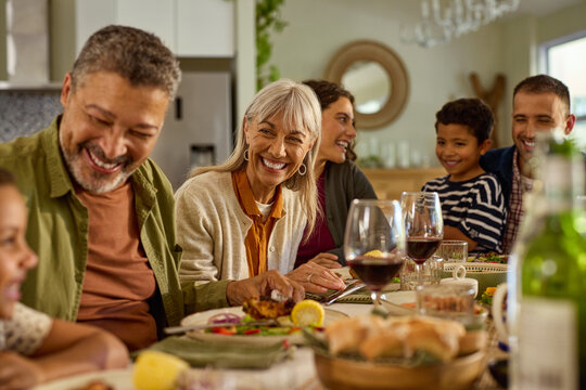 Joyful mature woman having lunch with family