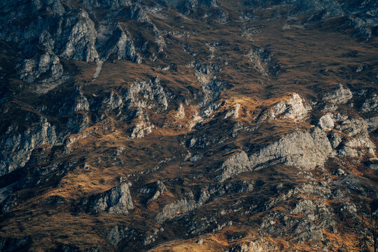 Sunlight highlights a rugged rocky mountainside