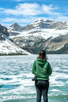Woman enjoying frozen Bow Lake in Banff National Park