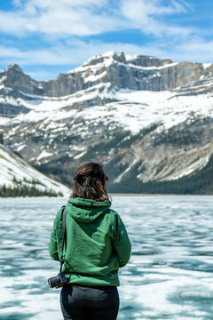 Woman enjoying frozen Bow Lake in Banff National Park
