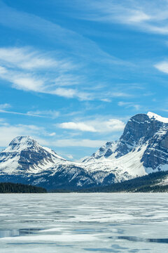 Frozen Bow lake and snow capped mountains in Banff National Park