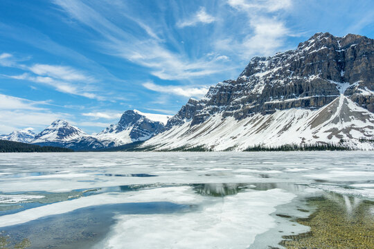 Frozen Bow lake and snow capped mountains in Banff National Park
