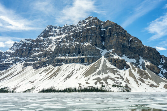 Frozen Bow lake and snow capped mountains in Banff National Park