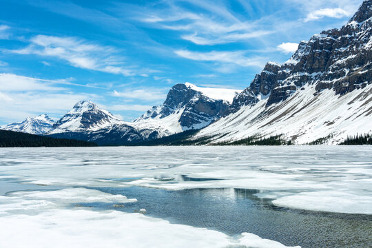 Frozen Bow lake and snow capped mountains in Banff National Park