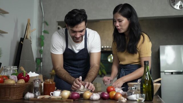 Man Sprinkles Flour on Dough as Woman Smiles