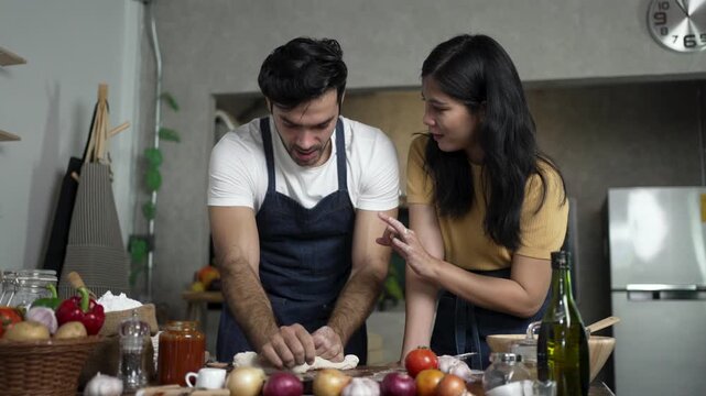 Woman Gives Thumbs Up as Man Kneads Dough