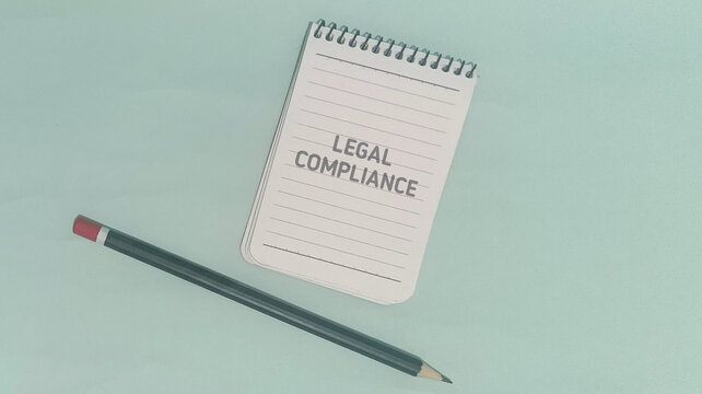 Legal Compliance Spiral Notepad and Pencil on Mint Green Background