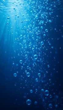 Underwater bubbles in blue ocean with sunlight rays