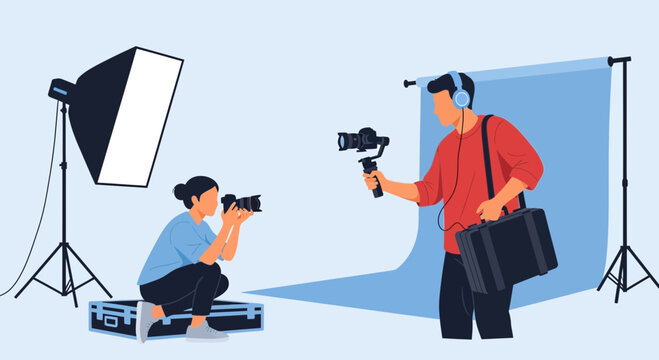 Videographer filming a photoshoot with a photographer documenting the process in a studio setup