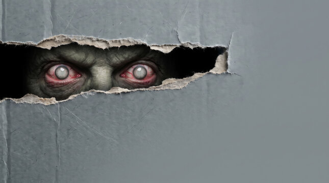 Monster eye peering through torn cardboard with scary shadow and eerie emotional tension. Halloween horror evil ghost. creepy supernatural creature nightmare, glowing darkness fantasy fear