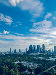 Fototapeta premium Aerial perspective of Benjakiti Park forest park surrounded by high-rise buildings in Bangkok