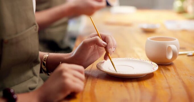 Woman, hands and painting in art class with ceramic plate, hobby and learning for skill development. Artist, person and creativity in workshop with paintbrush, pottery and tools for craft project.