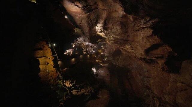 Illuminated pathway inside a large natural cave