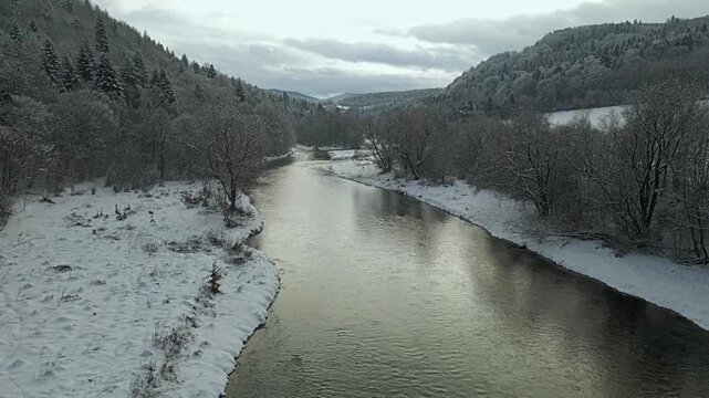 Aerial view of the Poprad River in Beskid Sadecki on a snowy ,winter day