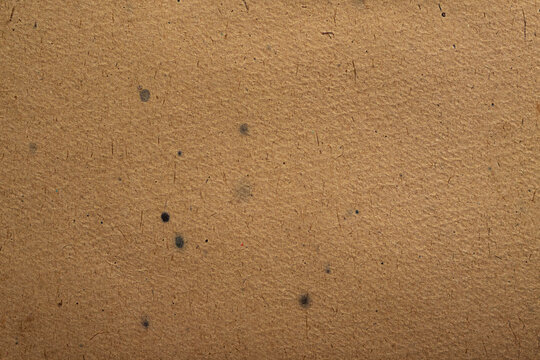 Brown recycled paper texture background with speckled cardboard and vintage craft surface