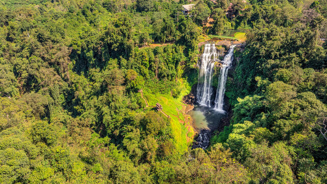 Aerial drone view of Tad Gneuang Waterfall in Laos, a spectacular tropical cascade surrounded by dense rainforest on the scenic Bolaven Plateau in Champasak Province.