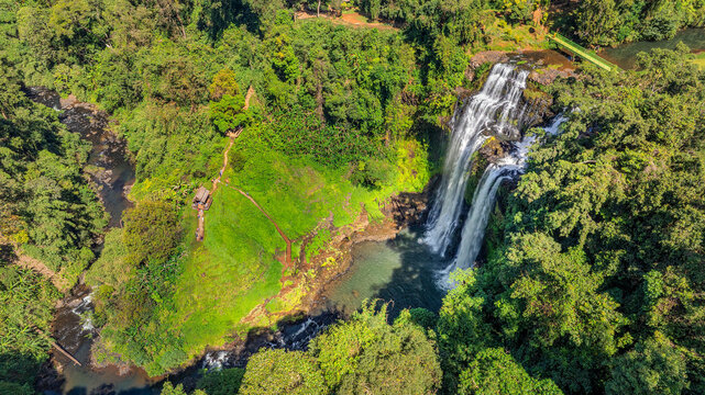 Aerial drone view of Tad Gneuang Waterfall in Laos, a spectacular tropical cascade surrounded by dense rainforest on the scenic Bolaven Plateau in Champasak Province.