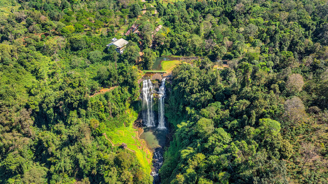 Aerial drone view of Tad Gneuang Waterfall in Laos, a spectacular tropical cascade surrounded by dense rainforest on the scenic Bolaven Plateau in Champasak Province.