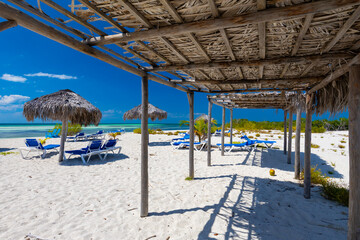 Tropical sandy beach and an exotic view of the Atlantic Ocean against a blue sky with clouds in Cuba, Caribbean – background for projects, wallpaper © anettastar