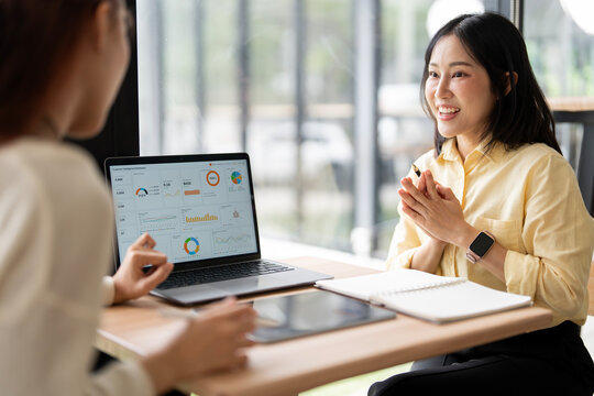 Asian Businesswoman Smiling and Clapping Hands During Project Presentation