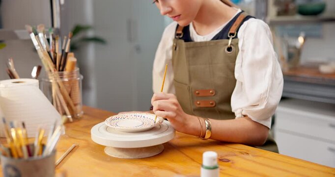 Hands, potter and painting in workshop for ceramic decoration, custom design or handmade creation. Pottery, woman or unique art on clay sculpture for small business order, production or color pattern