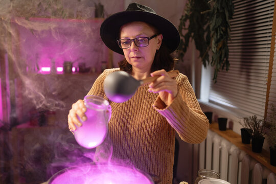 realistic witch witchcrafting brewing potion in cauldron. Everyday life intertwined with traditional witchcraft, magic and mystical atmosphere.