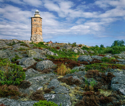 Stone wall lighthouse on scenic coastline