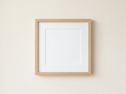 Minimalist wooden picture frame with white mat on a neutral wall.
