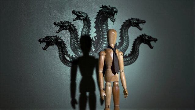 Wooden mannequin stands before shadowy, menacing multi-headed dragon projection.