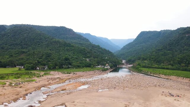 Tranquil border hill with dry riverbed and stones at Sylhet, Bangladesh india border - aerial panning shot.