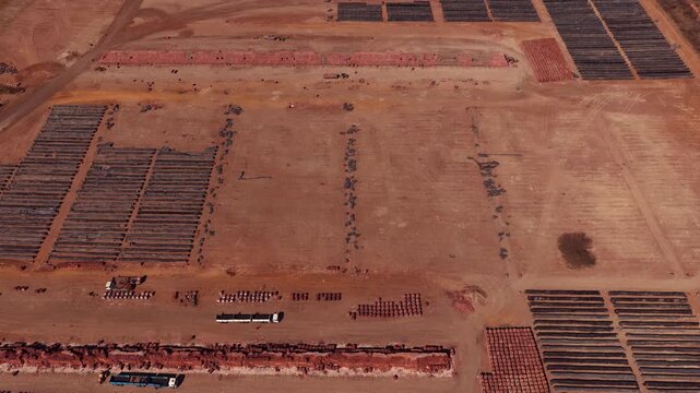 Brown dusty landscape around brickyard in South Africa, aerial tilt-up reveal