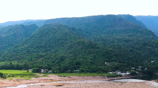 Beautiful border hill with dry riverbed and tribal settlement at Sylhet, Bangladesh india border - aerial panning shot.