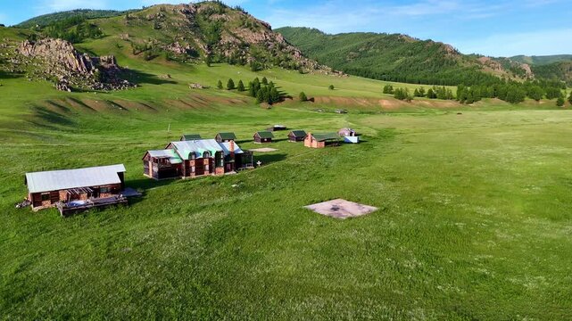 Aerial drone footage of vast green landscapes and rolling grasslands across the Mongolian countryside.