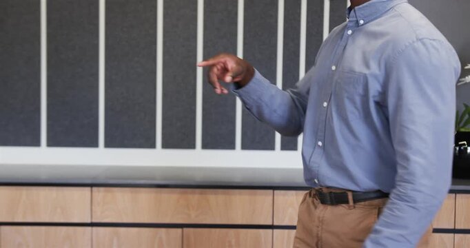 Close up of people talking to the camera, presenting in office, african american male pointing at sc