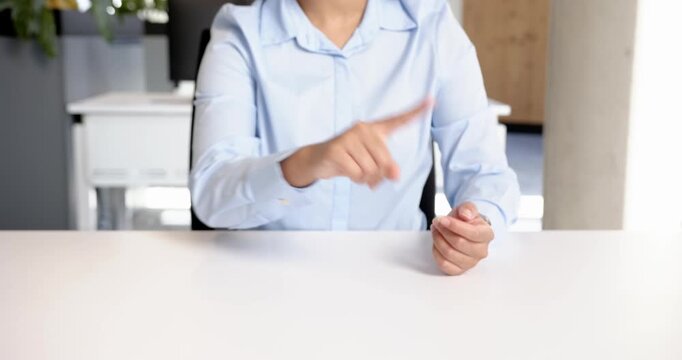 Close up of people talking to the camera, businesswoman in blue shirt gesturing with hands while sit