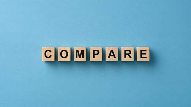 The word compare spelled with wooden blocks on a blue background. Excellent concept for business analysis and decision making presentations.