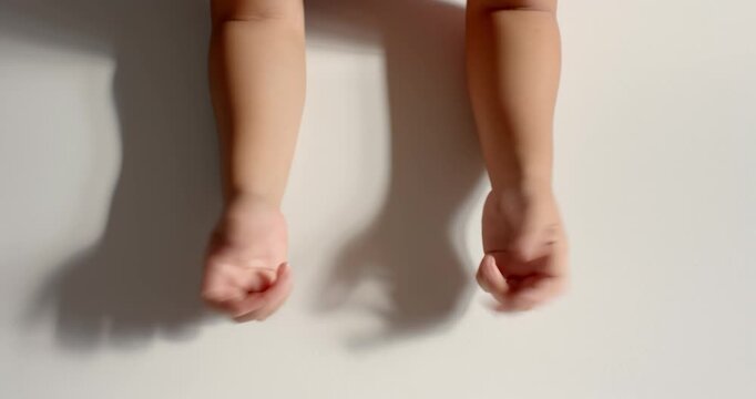 Close up of people talking to the camera, hands making shadow puppets on wall, engaging in playful a