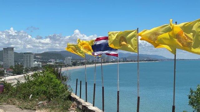 Flags fluttering in the breeze along the scenic coastline of Hua Hin Thailand
