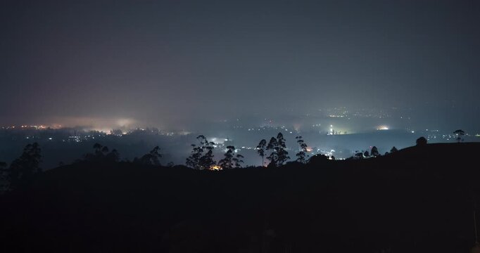 Timelapse of a rural town blanketed by the fog at night