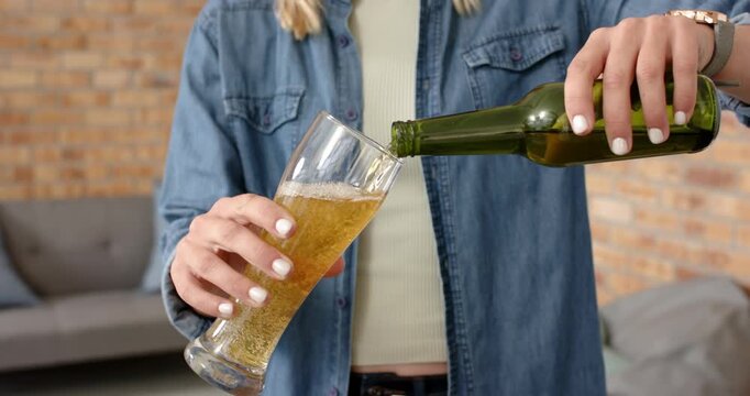 Lifestyle videos indoor of people doing activities at office, smiling woman enjoying glass of beer,