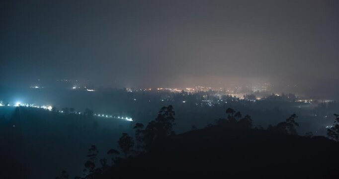 Timelapse of a rural town blanketed by the fog at night