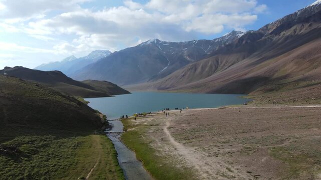 Drone view of Chandratal surrounded by mountain landscape in Spiti Valley, Himachal Pradesh