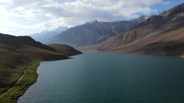 Chandratal surrounded by mountain landscape in Spiti Valley, Himachal Pradesh