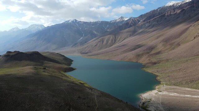 Drone view of Chandratal surrounded by mountain landscape in Spiti Valley, Himachal Pradesh