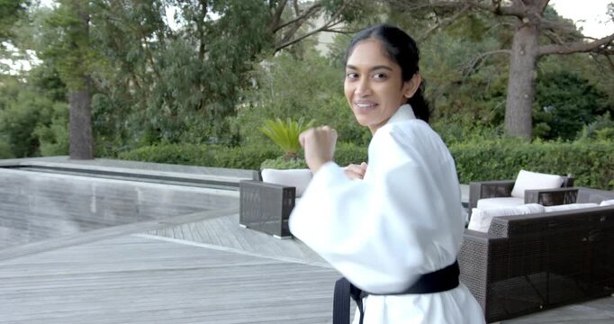 Lifestyle videos outdoor of people doing activities , practicing martial arts, woman in karate unifo