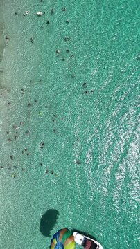 Mediterranean beach life with boat and Parasailing in Mallorca