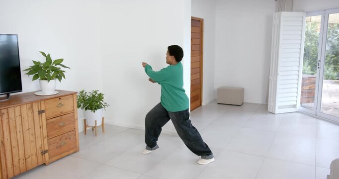 High speed photography for dynamic scenes, walking indoors, person in green sweater moving across mo
