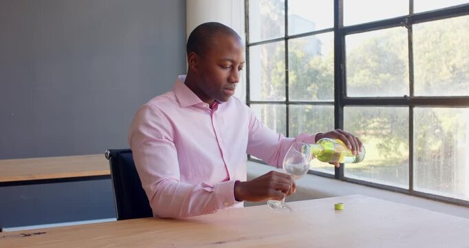 Lifestyle videos indoor of people doing activities at office, sitting at desk, man in pink shirt tas