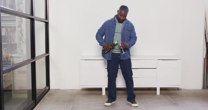 Lifestyle videos indoor of people doing activities at office, holding wine glass, man standing in mo