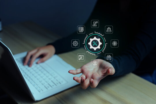 Woman Showing Holographic IT Service Icon while Typing on Laptop